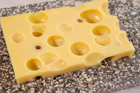 Cheese collection, semi-hard French cheese emmentaler with round holes made from cow milk close upの写真素材
