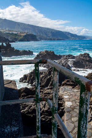 View on black lava rocks in small fisherman village Punta Brava near Puerto de la Cruz, Tenerife, Canary islandsの写真素材
