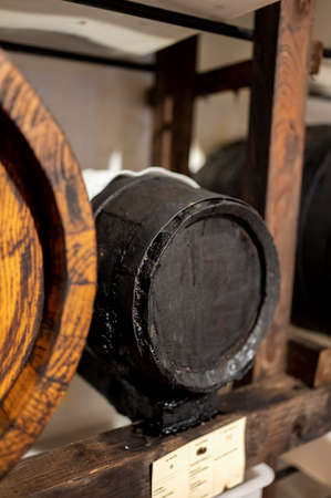 Traditional production and aging in wooden barrels of black Italian Balsamic wine IGP and DOC vinegar dressing in Modena, Italyの写真素材