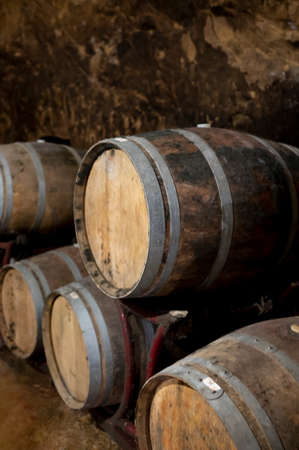 Medieval underground wine cellars with old red wine barrels for aging of vino nobile di...