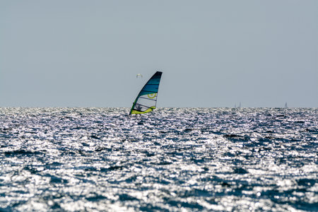 2021. Extreme water sports - wing foil, kite surfing, wind surfindg, windy day on Almanarre beach...