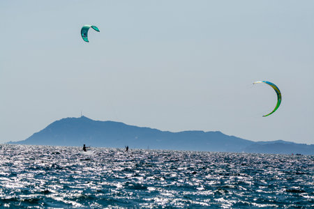 2021. Extreme water sports - wing foil, kite surfing, wind surfindg, windy day on Almanarre beach near Toulon, South of Franceのeditorial素材