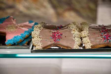 Sweet colorful bow-shaped biscuits on display at Italian bakery