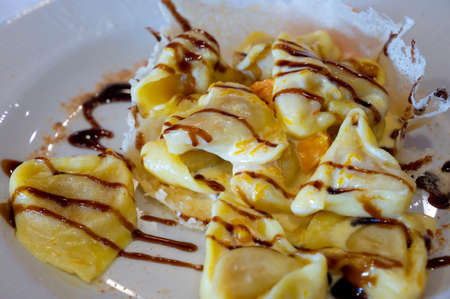 Italian food, fresh home made pumpkin stuffed pasta tortellini or ravioli dumplings with parmesan...