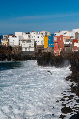 View on colorful houses and black lava rocks in small fisherman village Punta Brava near Puerto de la Cruz, Tenerife, Canary islands, Spain in winterの写真素材