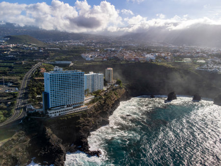 Aerial view on black lava rocks and Atlantic ocean in small fisherman village Punta Brava near Puerto de la Cruz, Tenerife, Canary islands, Spain in winterのeditorial素材