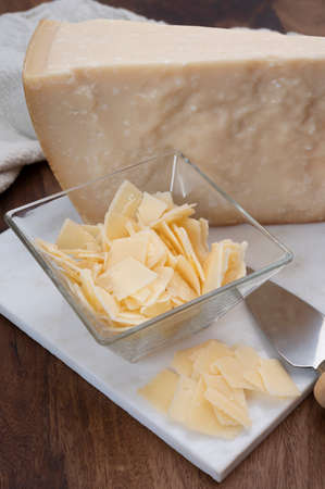 Flakes of parmesan cheese, italian hard parmigiano-reggiano cheese from Reggio Emilia region, close upの写真素材