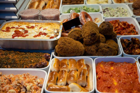 Assortment of gourmet meat dishes in butchery delicatessen shop, food background