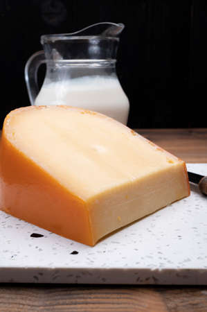 Piece of Dutch Gouda cheese ade from cow milk close upの写真素材