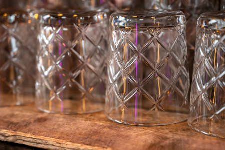 Many empty clean crystal glasses for water and drinks close upの写真素材