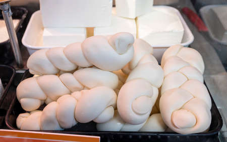 White soft braid cow cheese on market display