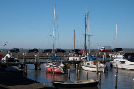 Walking on sunny spring day in small Dutch town Marken with wooden houses located on former island in North Holland, Netherlandsの写真素材