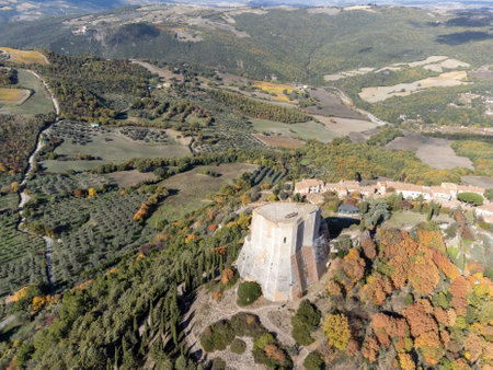 Medieval fortification castle on hilltop and view on hills in Tuscany, Italy in autumnのeditorial素材