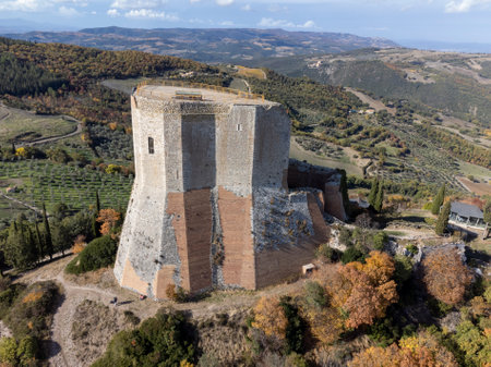 Medieval fortification castle on hilltop and view on hills in Tuscany, Italy in autumnのeditorial素材