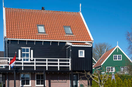 Walking on sunny spring day in small Dutch town Marken with wooden houses located on former island in North Holland, Netherlandsの写真素材