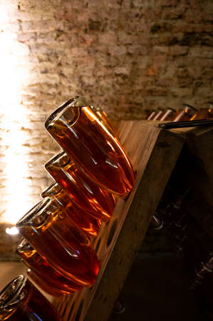 Sparkling white and rose wine production by traditional method in underground cellars in Vienna,...
