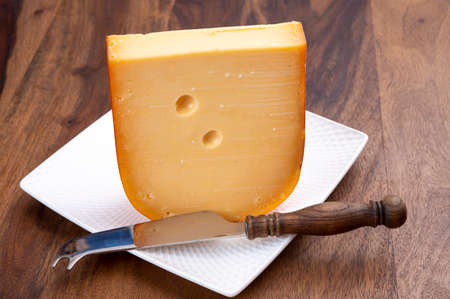 Dutch hard cow milk old yellow cheese from Goudaの写真素材