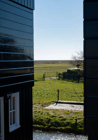 Walking on sunny spring day in small Dutch town Marken with wooden houses located on former island in North Holland, Netherlandsの写真素材