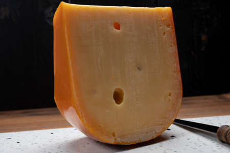 Piece of Dutch Gouda cheese ade from cow milk close upの写真素材