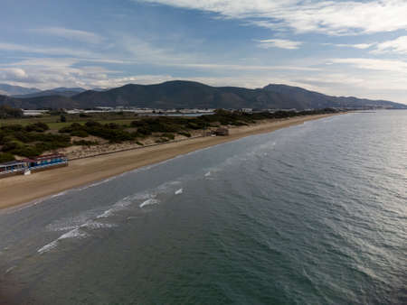 Aerial view on sandy beach and coastline of Tyrrhenian sea between two touristic towns Sperlonga and Terracina in Lazio, Italy in autumnの写真素材