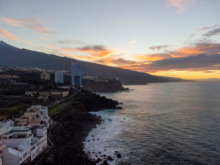 View on colorful houses and black lava rocks in small fisherman village Punta Brava near Puerto de la Cruz, Tenerife, Canary islands at sunsetの写真素材