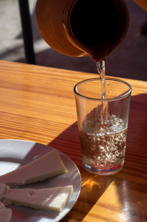 Dinner at guachinche, typical Canary Island establishment on Tenerife, where locally produced white or red wine reserved accompanied by homemade traditional food in sunny day.の写真素材