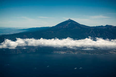 Flying propeller plane around Tenerife island with peak of Mount Teide, volcatic landscape, Canary...