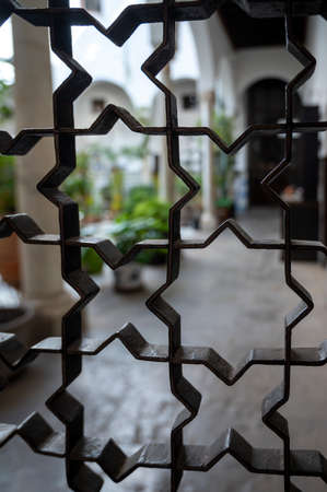 Example of medieval moorish symmetrical and geometrical ornaments on iron doors in Granada,...