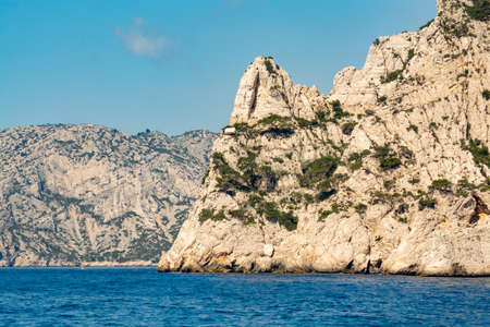 Limestone cliffs and blue sea near Cassis, boat excursion to Calanques national park in Provence,...
