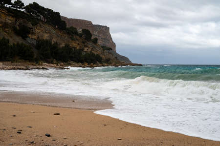 Storm on sea, high waves on yellow sandy beach in Cassis, Provence, France