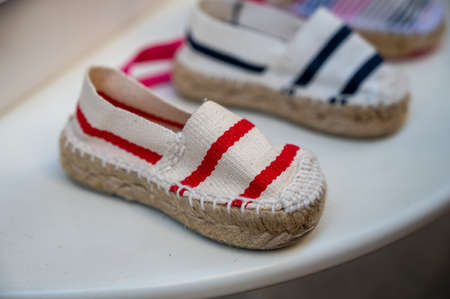 Traditional Spanish shoes for summer, espadrilles, make from soft fabric for baby, children and adults, close up.の写真素材