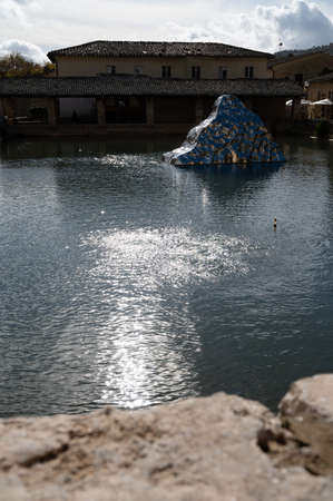 Ancient natural hot springs stone pool in small Italian village Bagno Vignoni in Tuscanyの写真素材