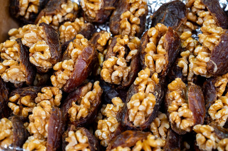 Turkish or arabic sweet dessert, ripe dried dates with walnuts sweetened with syrup or honey, close...