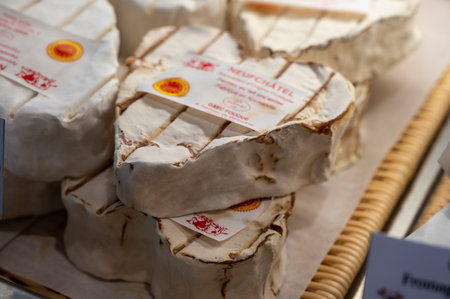 French heartshaped neufchatel cow cheese for sale in farmers dairy shop, french text on lables means Neufchatel cheese, made from farmers milk in Normandy, Franceのeditorial素材