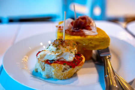 Assortment of typical snacks of Basque Country and Navarre, pinchos or pinxtos, small piece of bread...