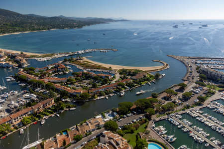 Aerial view on blue water of Gulf of Saint-Tropez, sail boats, houses of Port Grimaud and Port Cogolin, summer vacation in Provence, Franceの写真素材