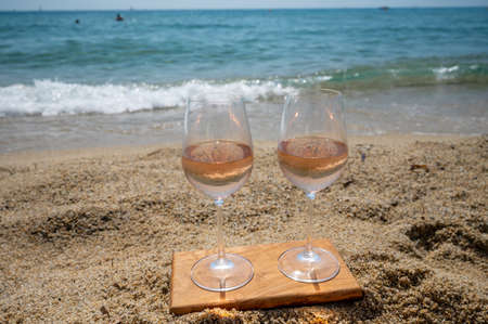Cold rose wine from Provence served outdoor on white sandy beach Plage de Pampelonne near Saint-Tropez, summer vacation in Franceの写真素材