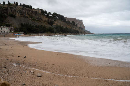 Storm on sea, high waves on yellow sandy beach in Cassis, Provence, France