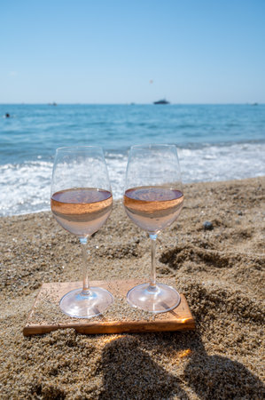 Cold rose wine from Provence served outdoor on white sandy beach Plage de Pampelonne near Saint-Tropez, summer vacation in Franceの写真素材