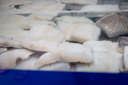White salted and dried bacalao codfish in water tank, traditional Spanish preserved seafood on...