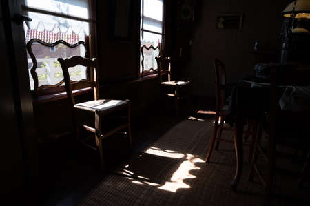 Old fashioned wooden chair in sunlights by window, Dutch interior and room decoration in rich fisherman's house in North-Holland, Enkhuizen, Netherlandsの写真素材