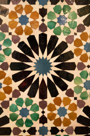 Ornamental medieval ceramic tiles of walls in Nasrid Palaces in the Alhambra palace Granada,...