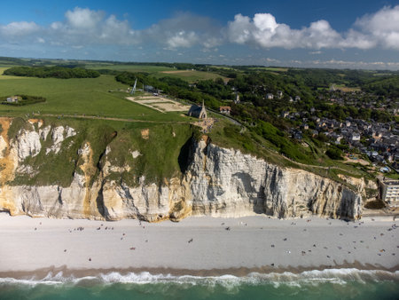 Low tide period and aerial view on white stones on ocean bottom and chalk cliffs of Porte d'Aval...