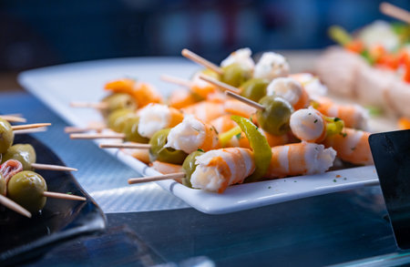 Typical snacks of Basque Country and Navarre, pinchos or pinxtos on skewers on display in bar, Bilbao, Spain, close upの写真素材