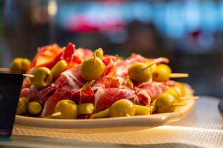 Typical snacks of Basque Country and Navarre, pinchos or pinxtos on skewers on display in bar, Bilbao, Spain, close upの写真素材
