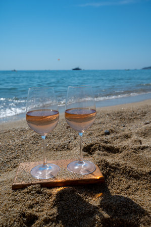 Cold rose wine from Provence served outdoor on white sandy beach Plage de Pampelonne near Saint-Tropez, summer vacation in Franceの写真素材