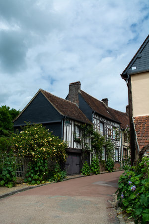 Tourist destination, one of most beautiful french villages, Gerberoy - small historical village with half-timbered houses and colorful roses flowers, Franceのeditorial素材