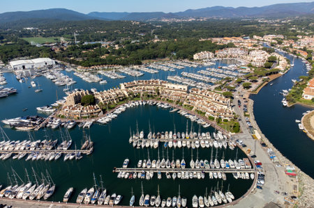 Aerial view on blue water of Gulf of Saint-Tropez, sail boats, houses of Port Grimaud and Port Cogolin, summer vacation in Provence, Franceのeditorial素材