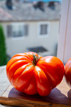 Fresh ripe colorful french tomatoes vegetables from Provence in wooden boxの写真素材
