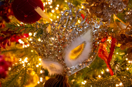 Christmas tree decorated is festivily decorated with vintage colorful balls, garlands and toys close...